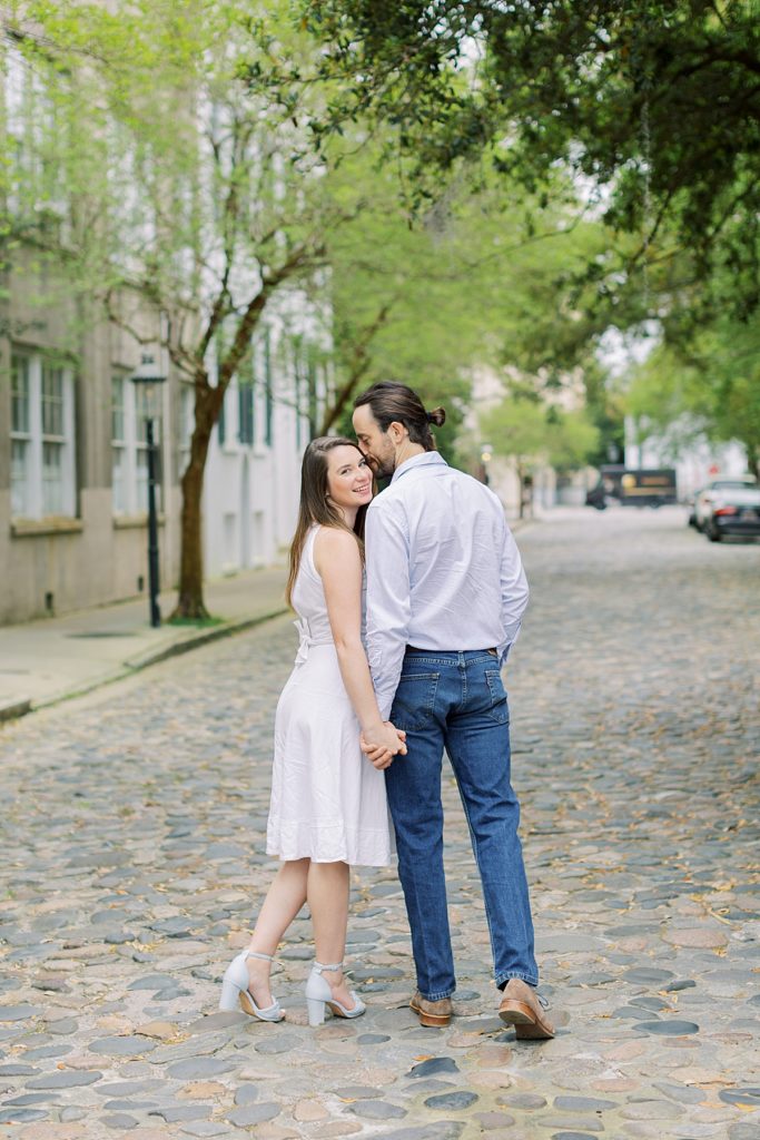 Couple walking down street from Charleston, South Carolina engagement session. Rachel Fugate Photography