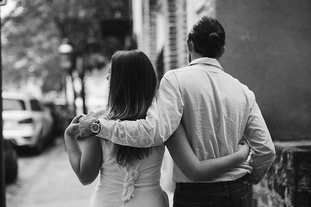Couple walking down street from Charleston, South Carolina engagement session. Rachel Fugate Photography