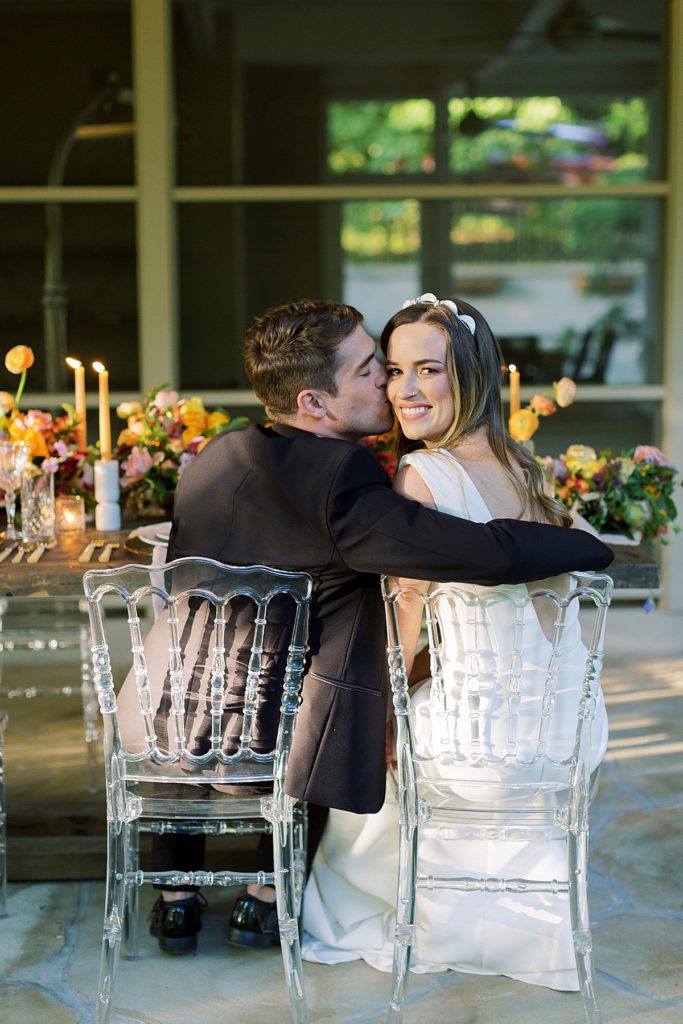 Groom kissing bride at the reception at The Milky Way House Wedding Venue in Knoxville, TN. 