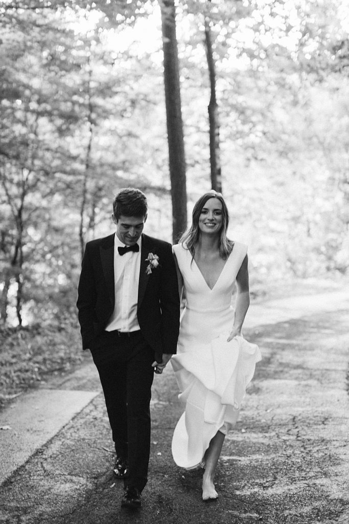 Bride and Groom walking in the woods after wedding at The Milky Way House Wedding Venue in Knoxville, TN. 