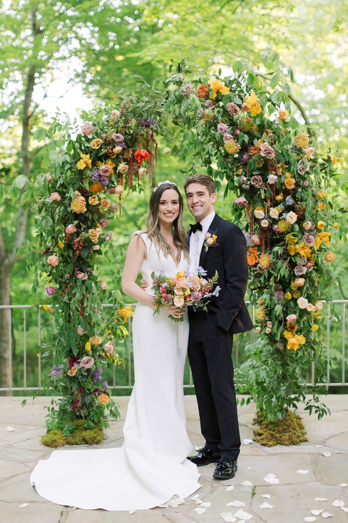 Bride and Groom under Wedding Floral Arch at The Milky Way House Wedding Venue in Knoxville, TN. 