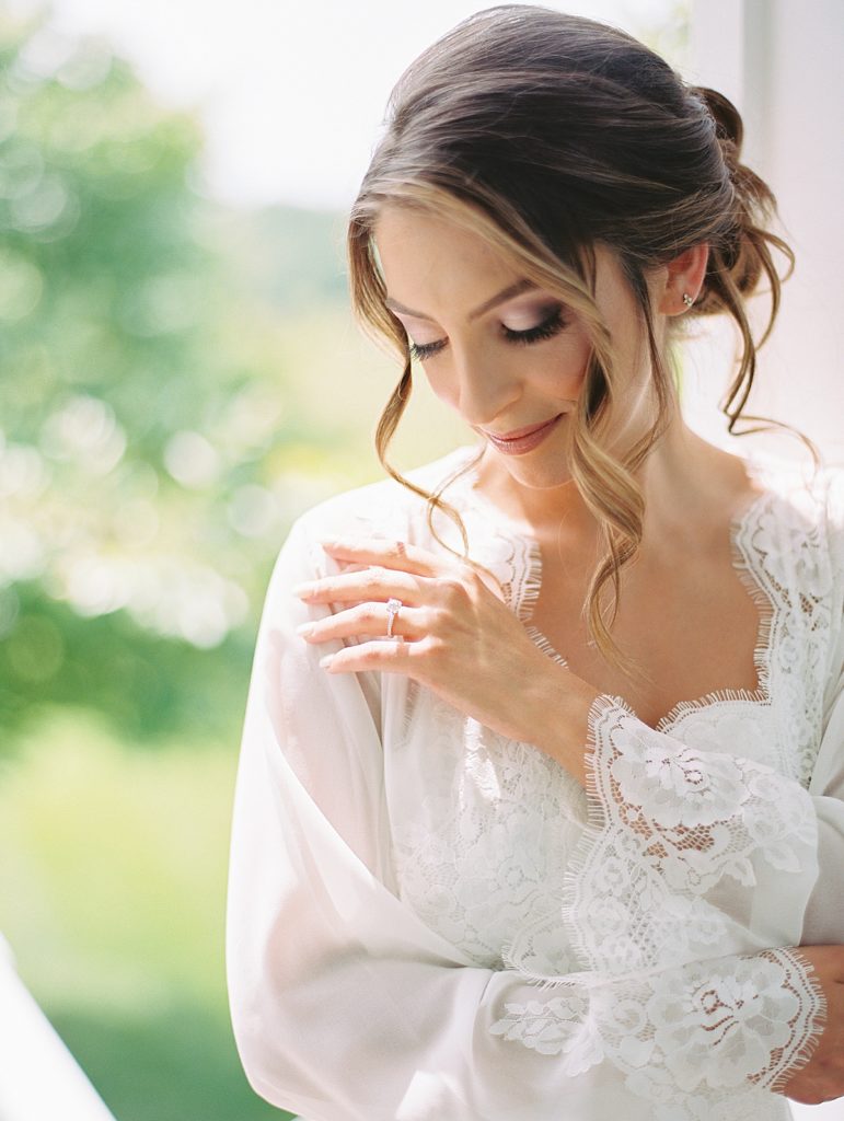 Beautiful bride looking down while getting ready. Rachel Fugate Photography