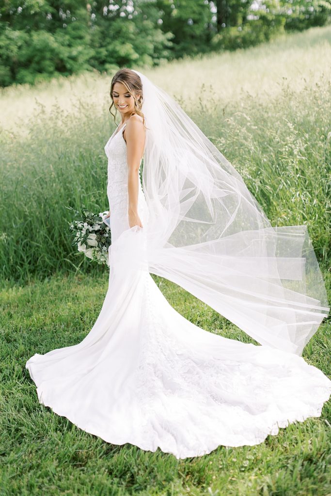 Bride with bouquet and long flowing veil at Mint Springs Farm - Rachel Fugate Photography